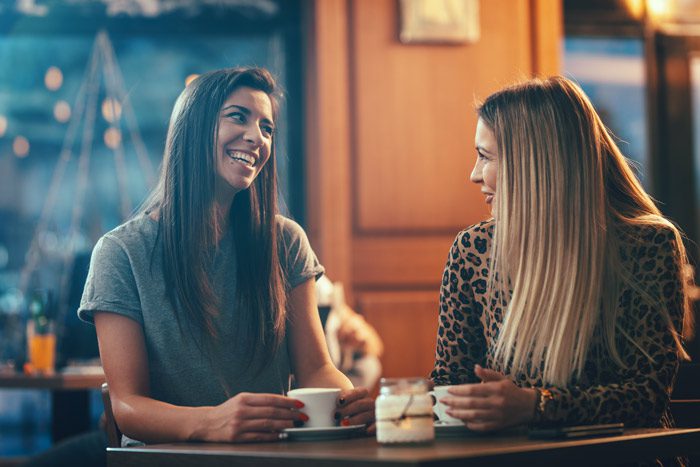 dealing with burnout, Feelings of burnout, Cope with Burnout in Recovery, two pretty young women talking and having coffee - friendship and support - burnout