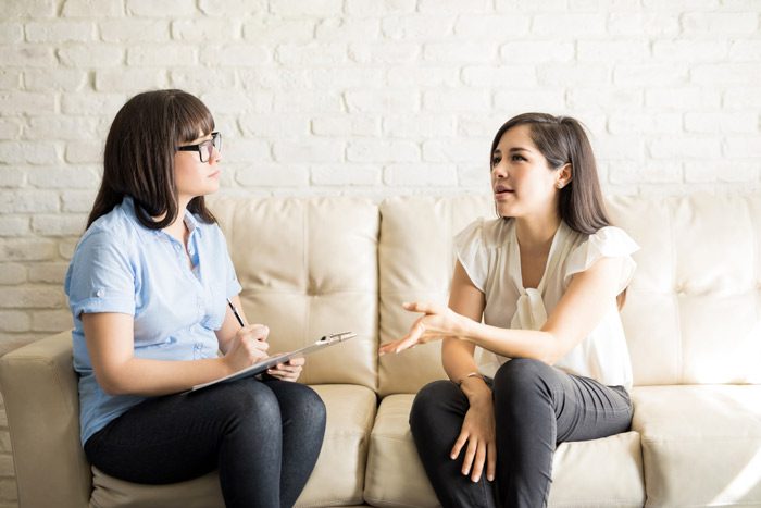 woman speaking with her female therapist during a session - Dialectical Behavior Therapy